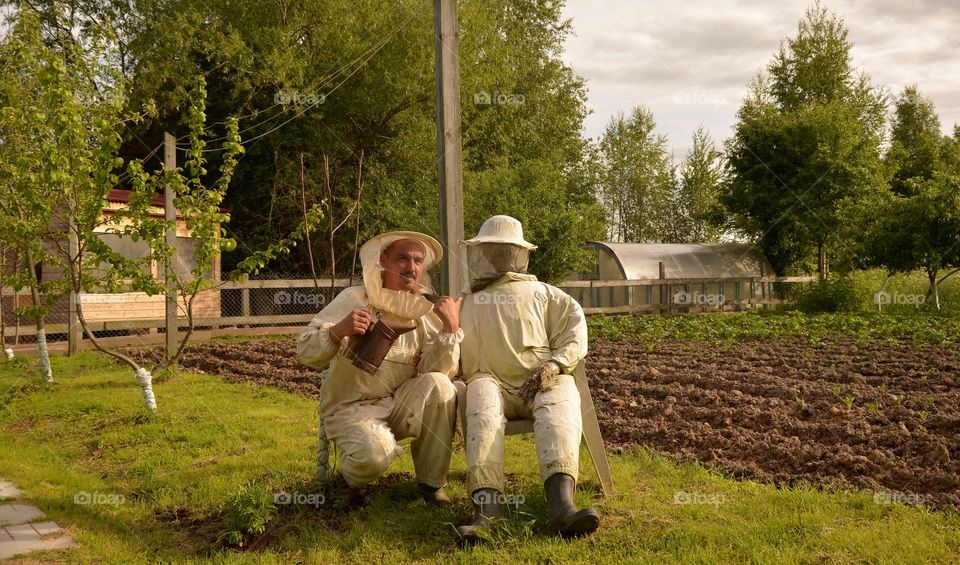 Portrait of honey bee keeper in farm
