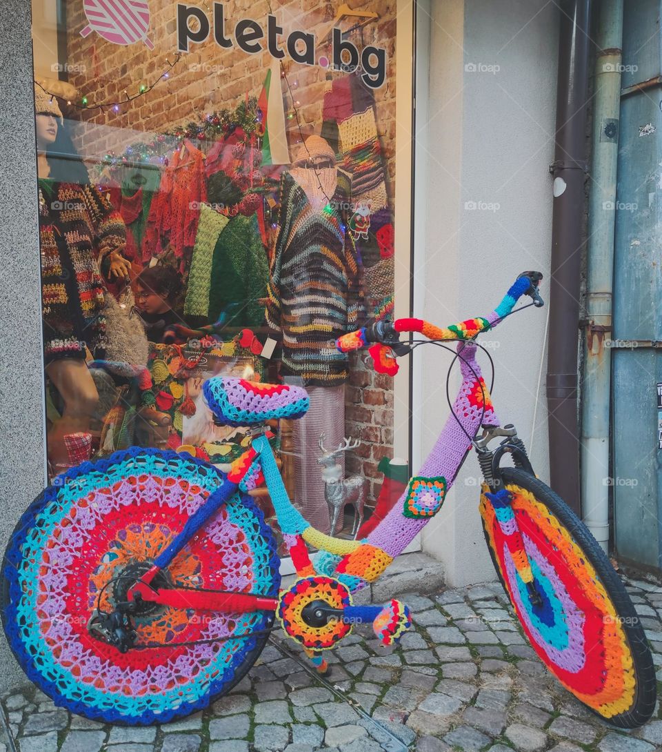 A colorful bicycle in front of a shop