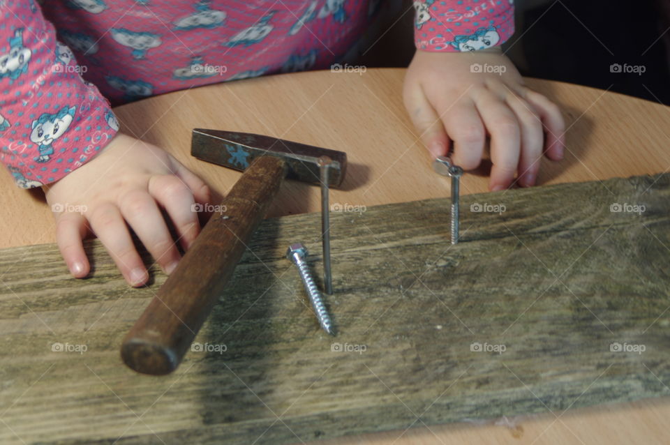 little girl holding tools