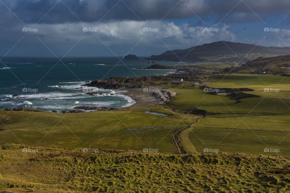 Scenic view of sea against cloudy sky