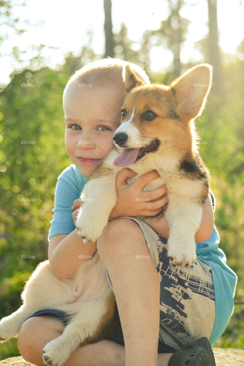 Happy boy holding cute dog