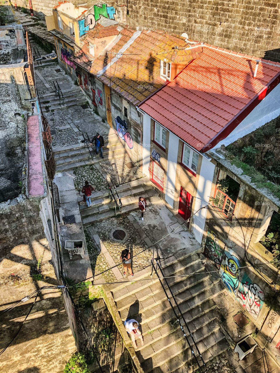 The view from up above a pedestrian stepped street in Porto, you can make out my shadow standing on the bridge above 