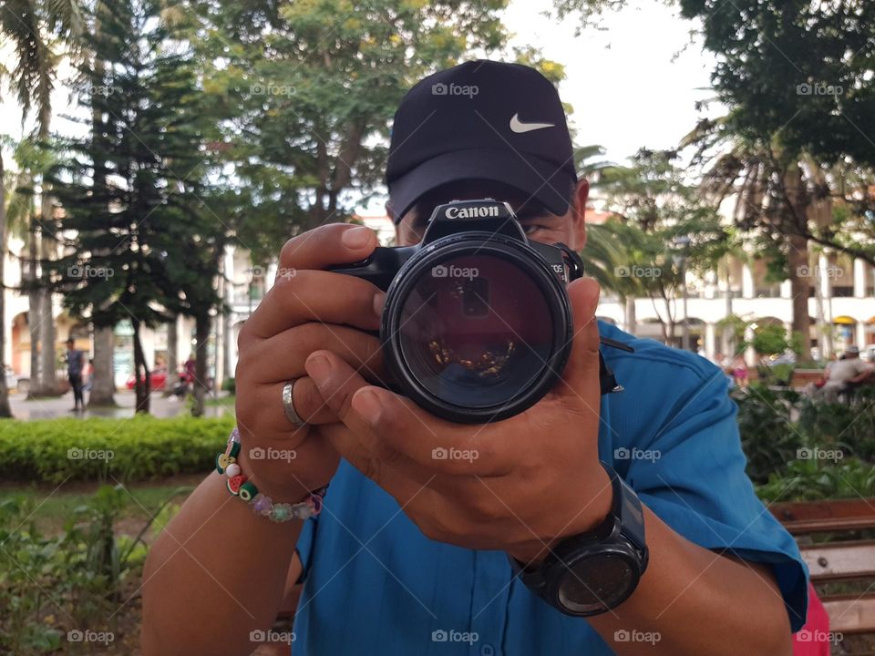 Man is taking a picture with his canon DSLR camera