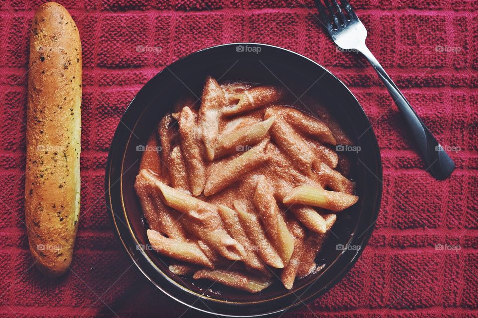 High angle view of pasta with breadstick