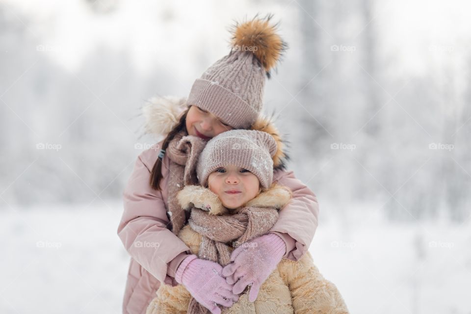 Little sisters in a winter park