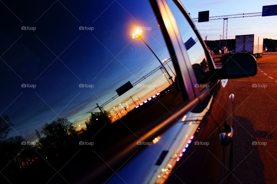 Evening reflection in window. Reflection of a setting sun and railroad yard in in a car window at the harbor of Turku, Finland.