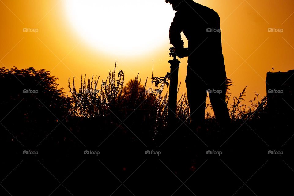 Boy with water pump