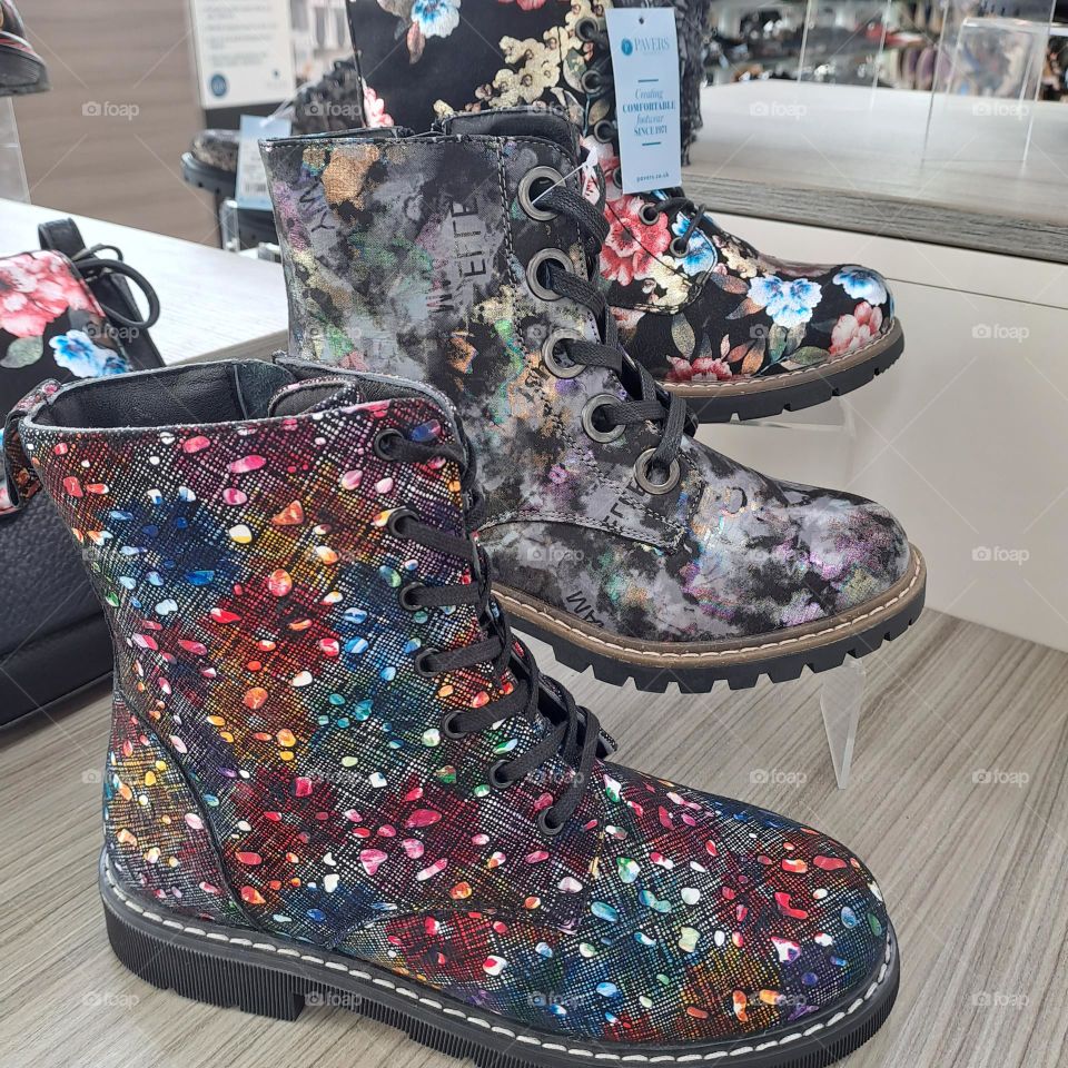 3 colourful design boots. shoe shop shelves