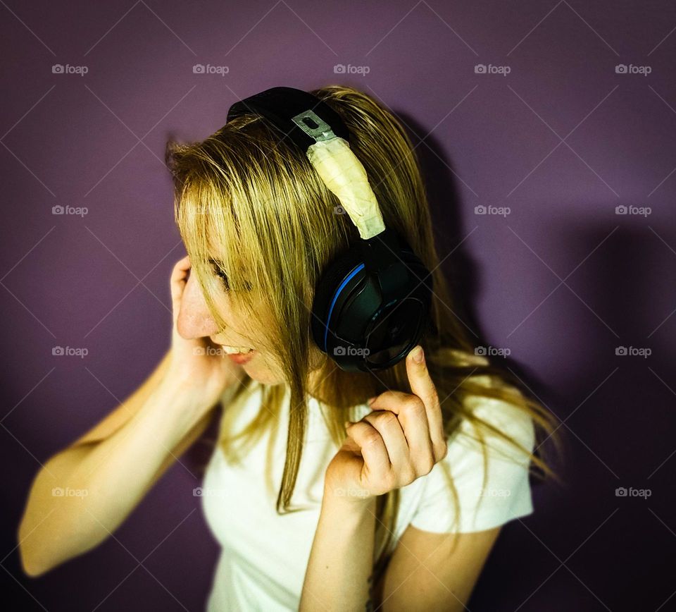 Girl gamer holding up her old gaming headset