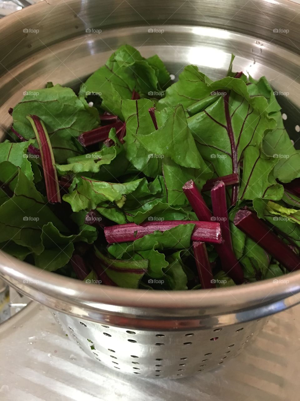 Stainless steel
Colander filled with freshly picked beet greens