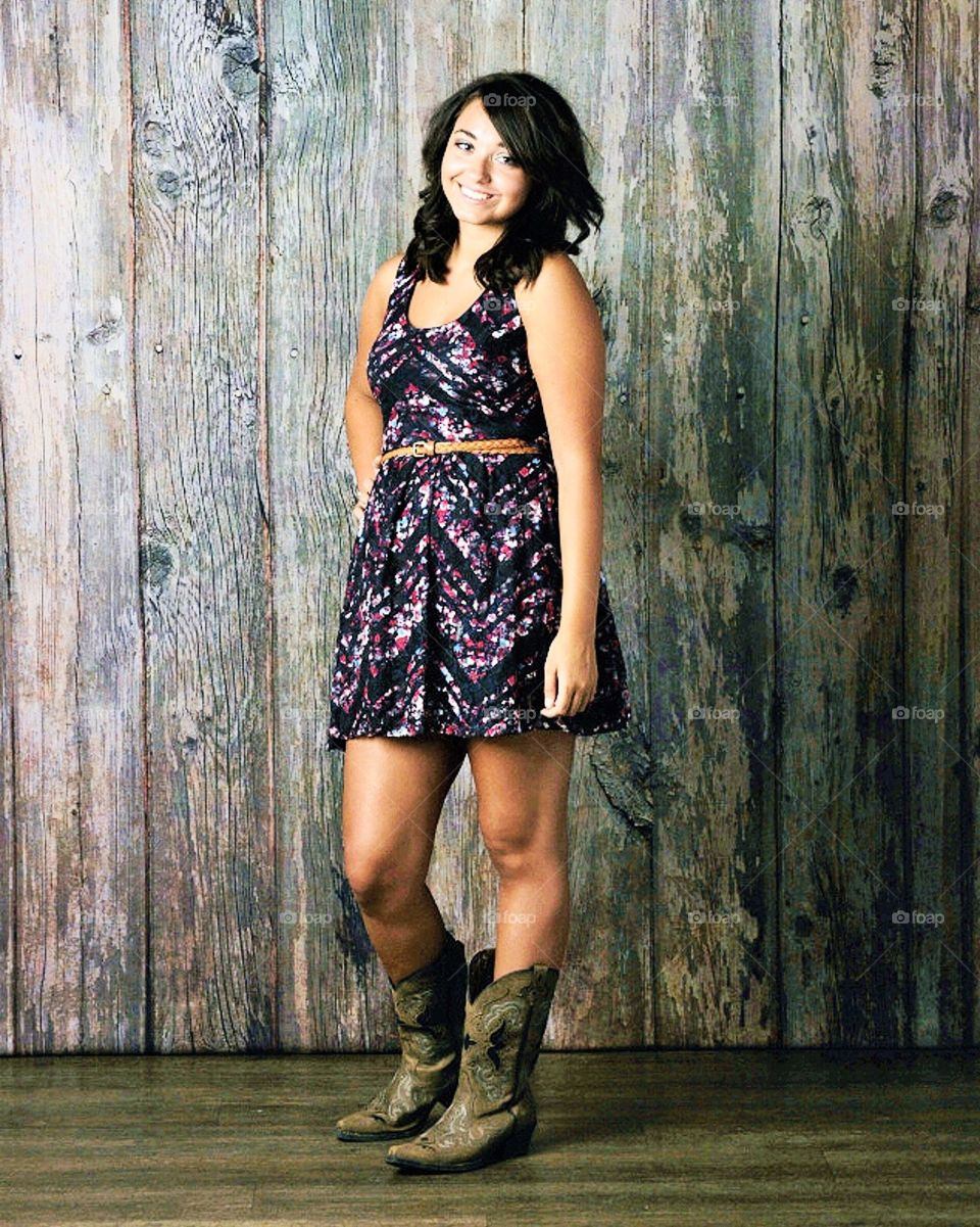 Portrait style posses of women in boots. A true southern girl. Perfect smile and center of attention. 