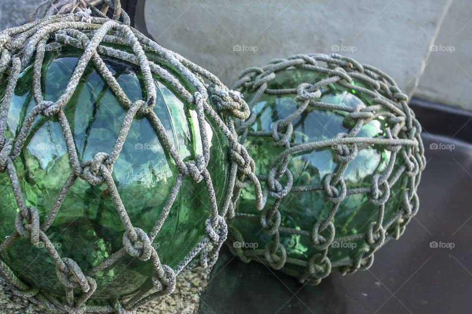 Vintage green glass fishing float balls knotted in jute rope