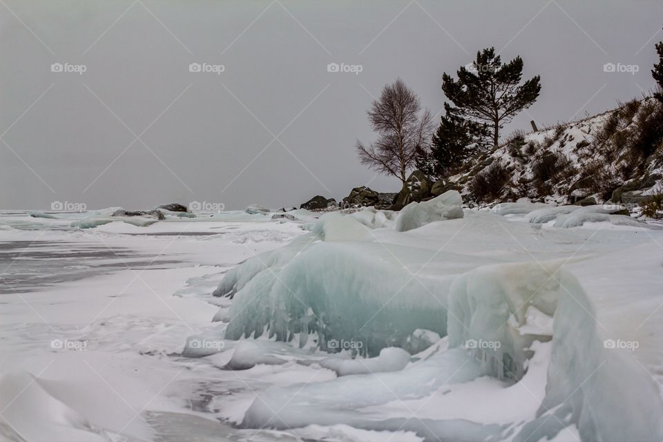 Frozen lake against the cloudy sky.