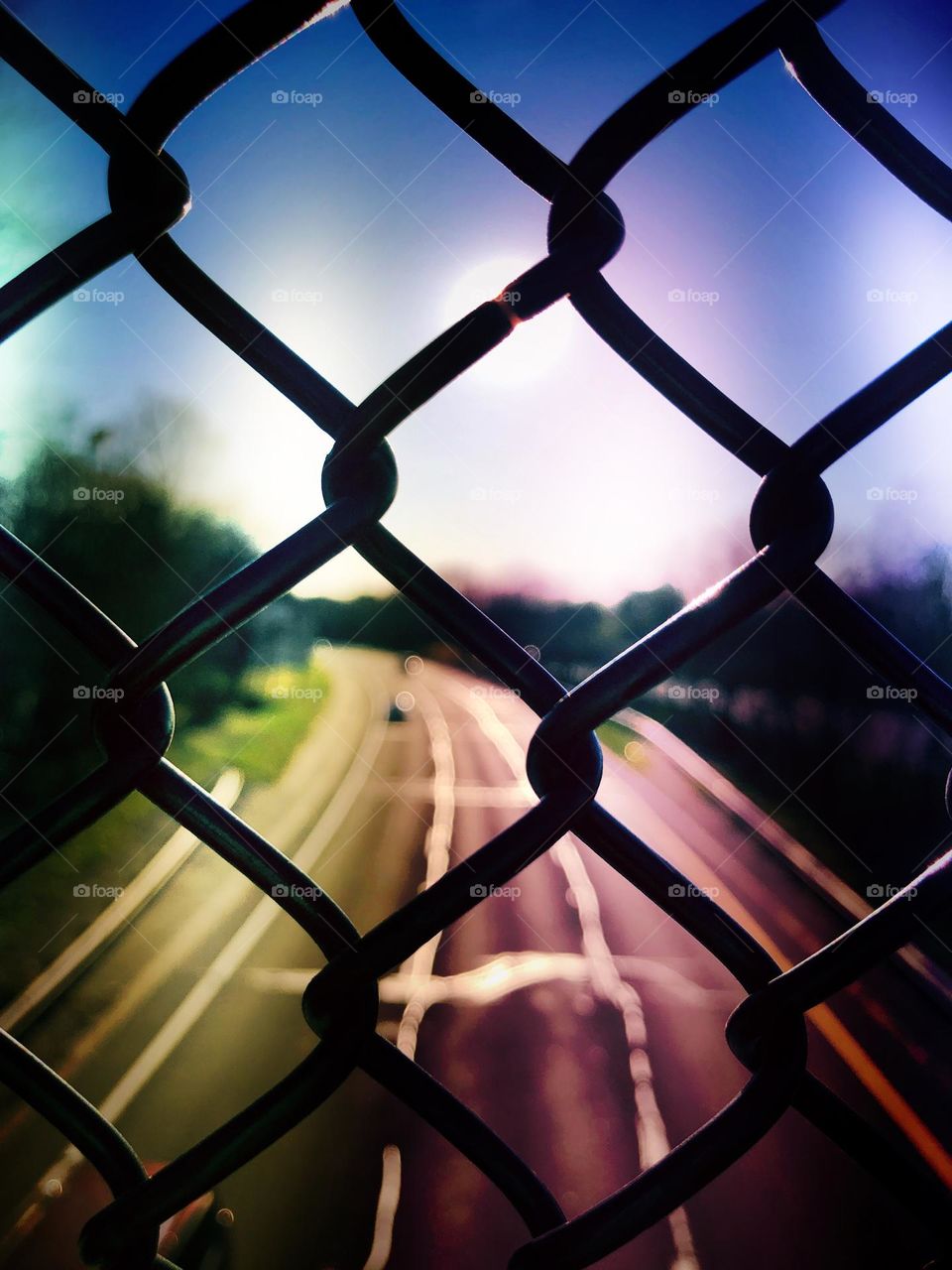 Highway behind metal fence