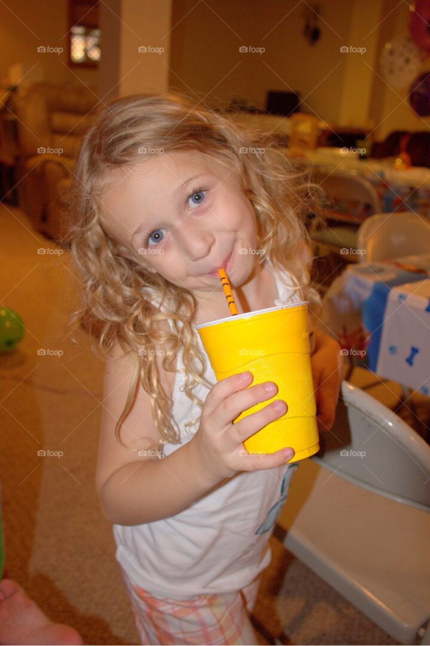 Close-up of a little girl sipping coffee