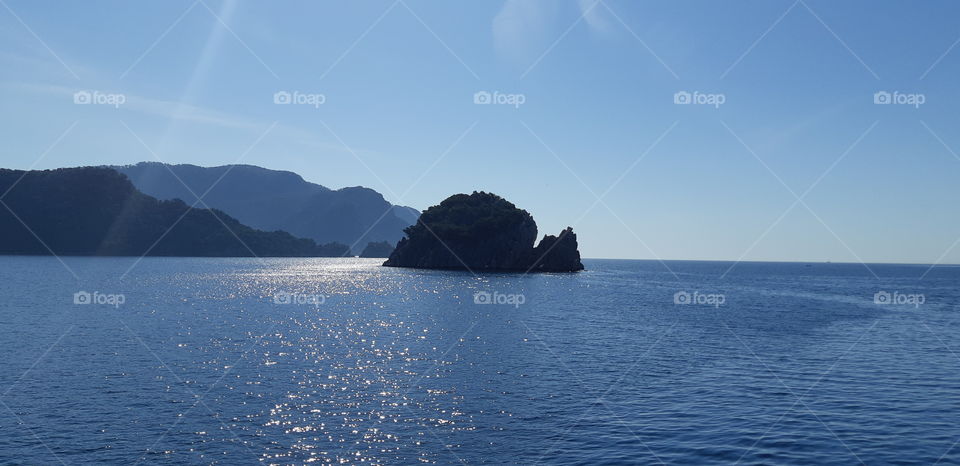 A lowly island with a calm blue sea