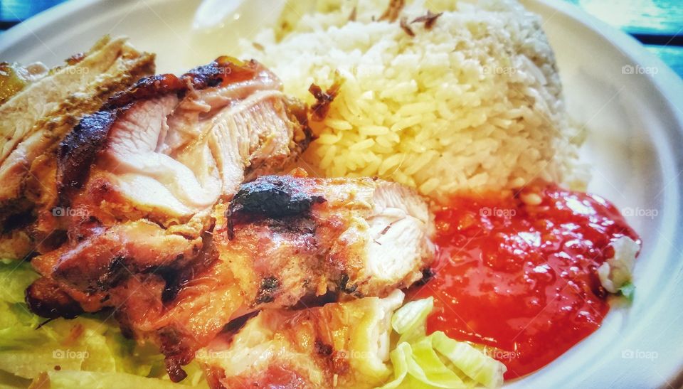 Fried chicken breast pieces served with Hainanese chicken rice and a special blend of chilli sauce.