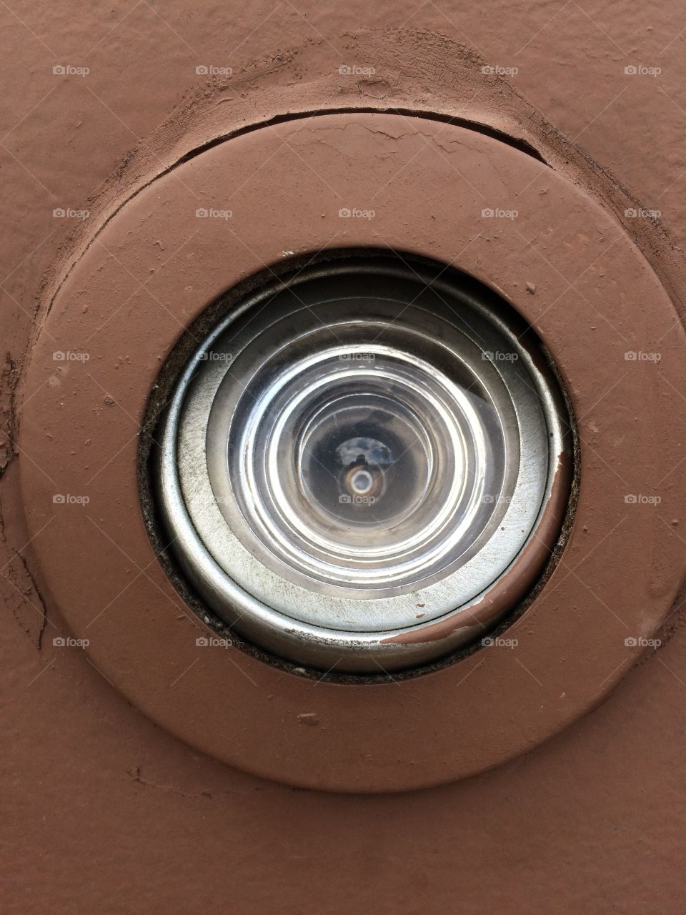 A peephole in a door taken straight on