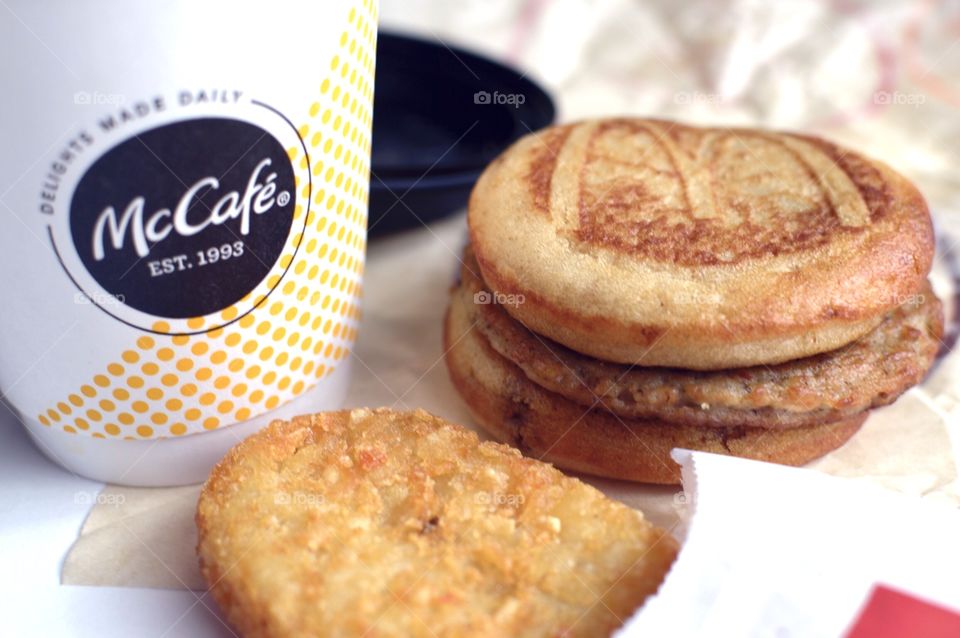 McDonald’s Mc Café sausage McGriddle hash brown close up side flat lay