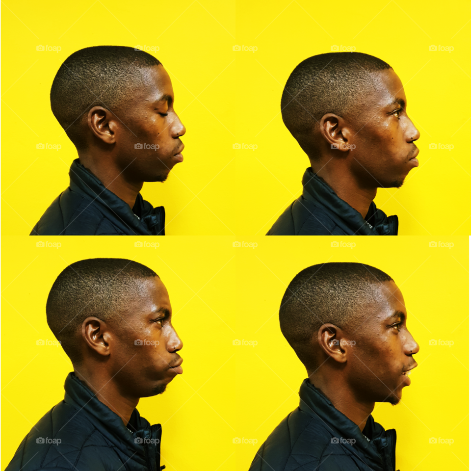 facial expression square; from a blank face, to a straight face, to a frown and finally ending with a smiley face. 
shot in a studio using a yellow backdrop.