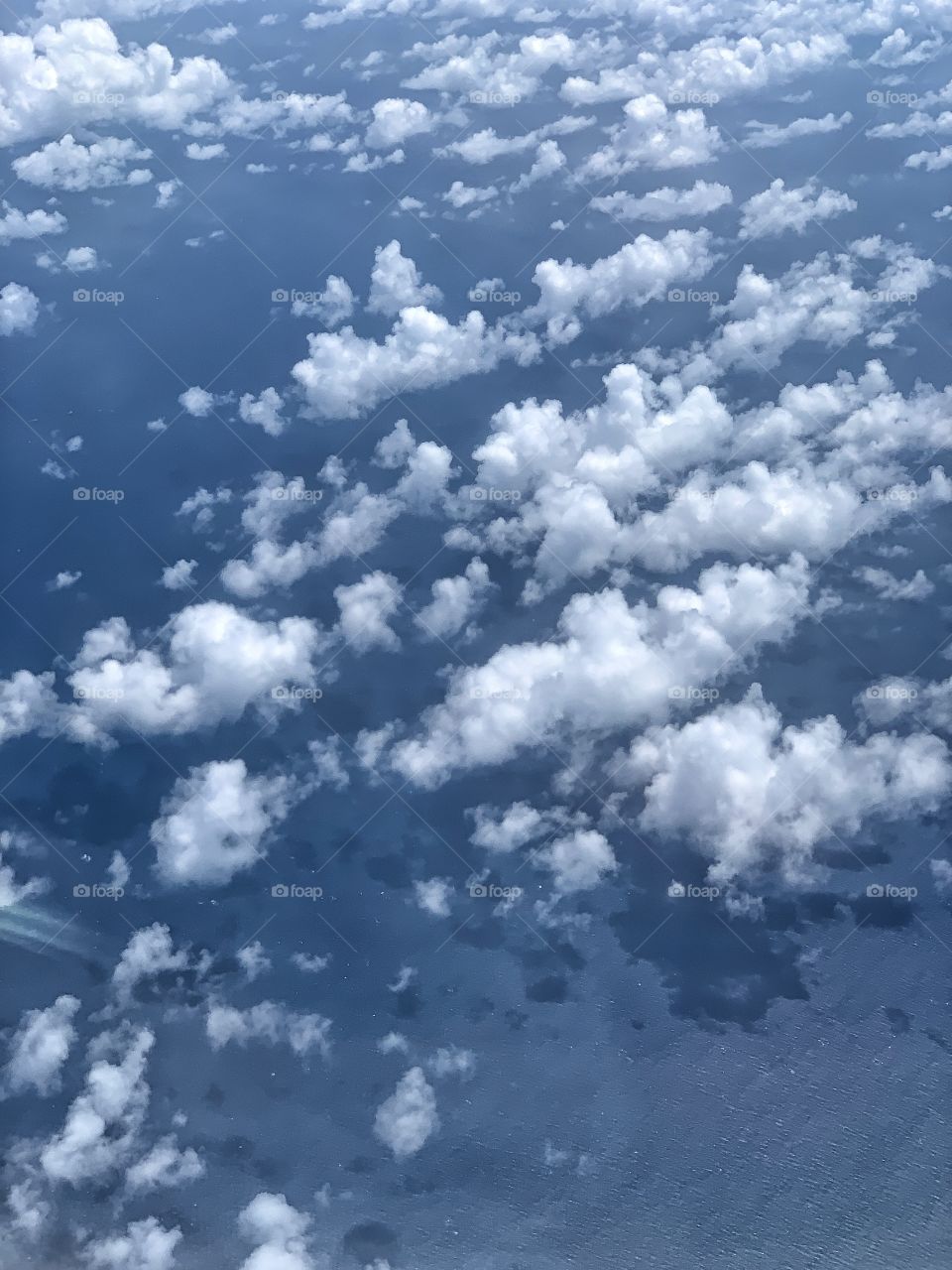 Beautiful white clouds in a sunny day above the sky. Fluffy, wavy, sky is blue, nature.