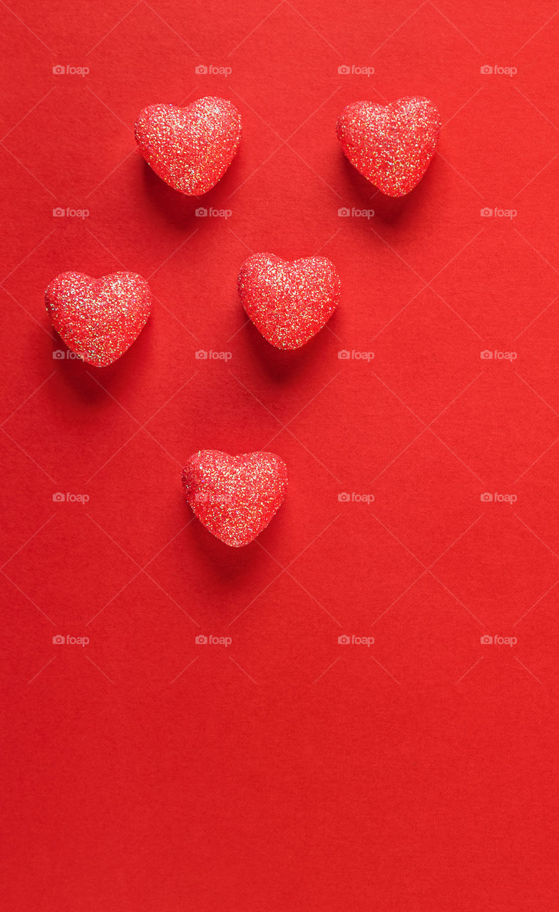 Red hearts on a red background. Valentine's Day.