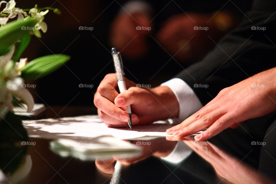 Man in suit signing documents, contract