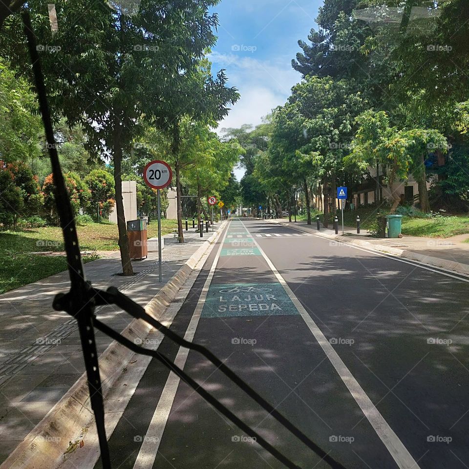 traveling by electric vehicle on empty streets with bicycle lanes on the side