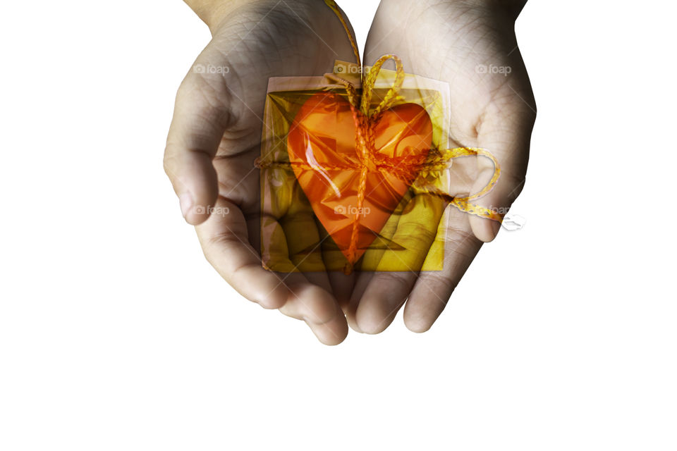 Isolated Hand holding a red candy shape heart in Gift box gold on a white background.