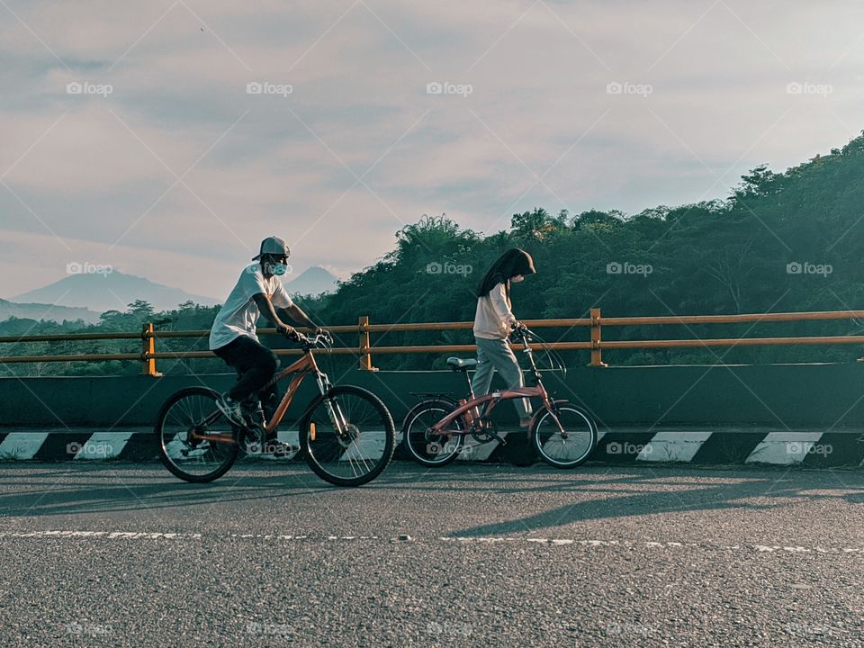 A man and a woman on a bicycle