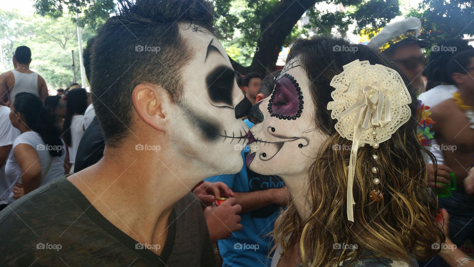 Close-up of a couple kissing with face paint