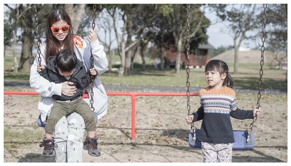 Japanese family on playground swing 