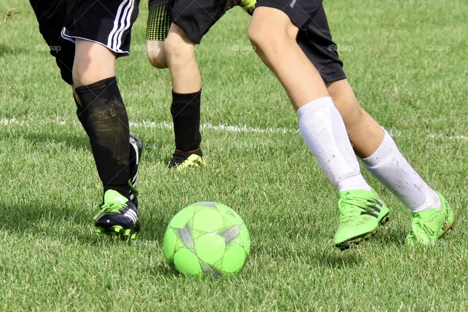 Soccer game, neon green shoes and soccer ball 