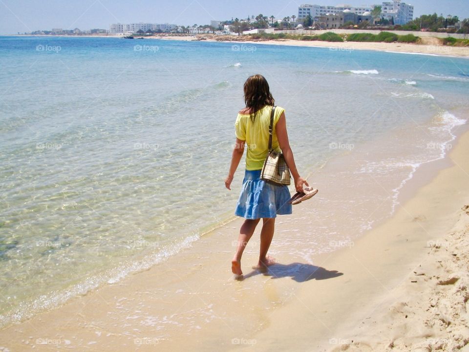 Young woman on a beach walk