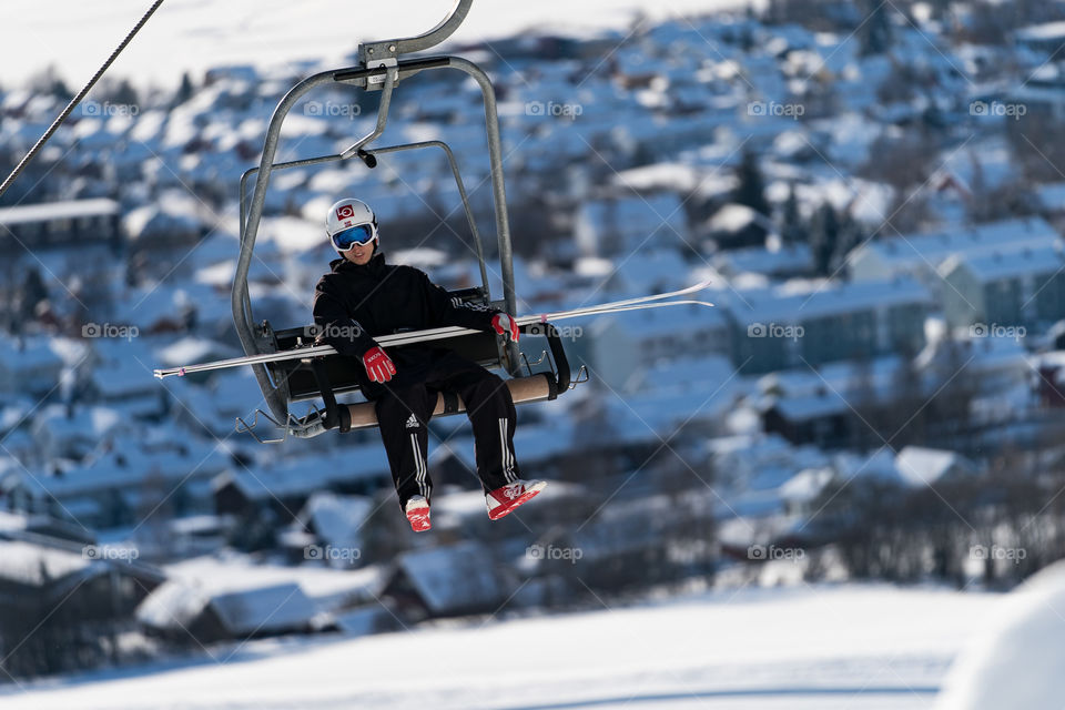 Ski jumper in lift to the top