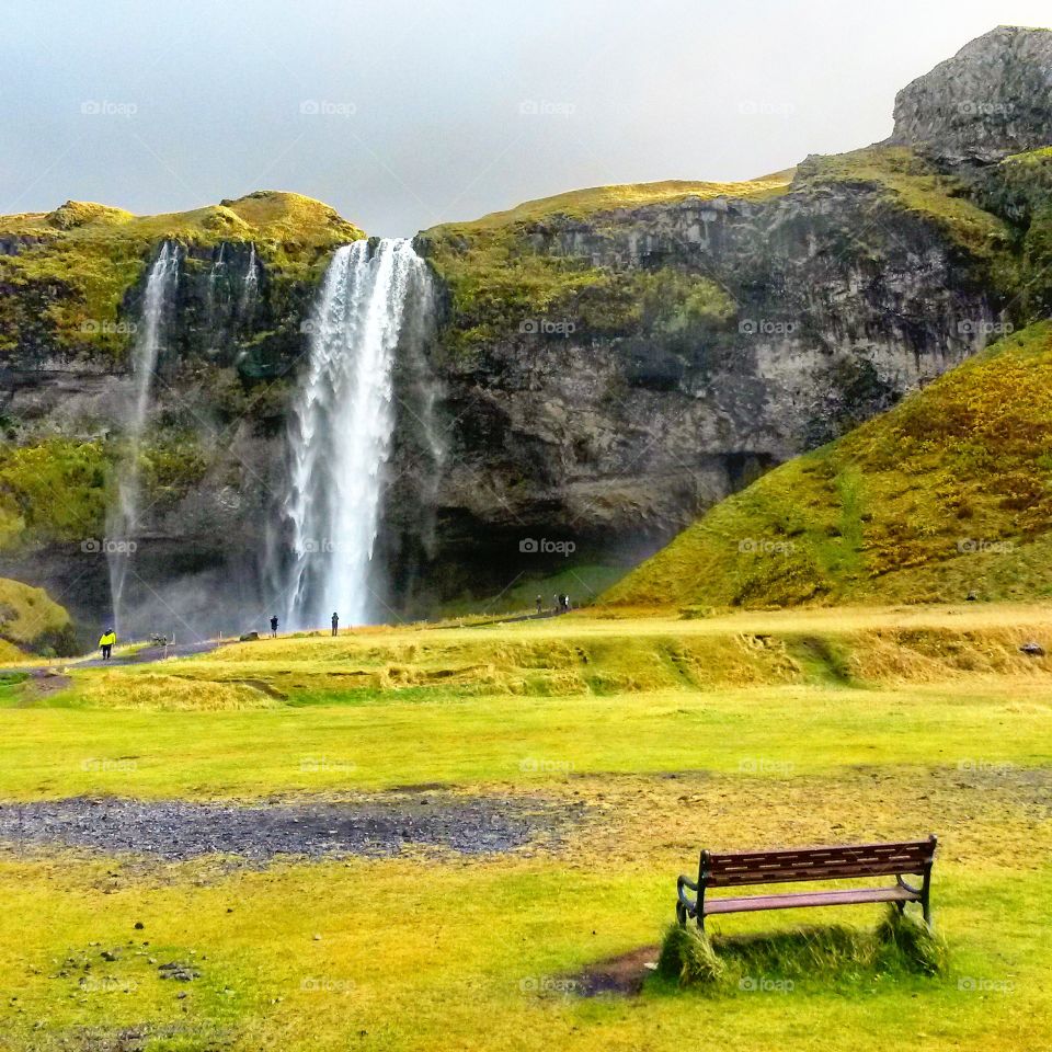 Quiet scene: bench overlooking waterfall in Iceland