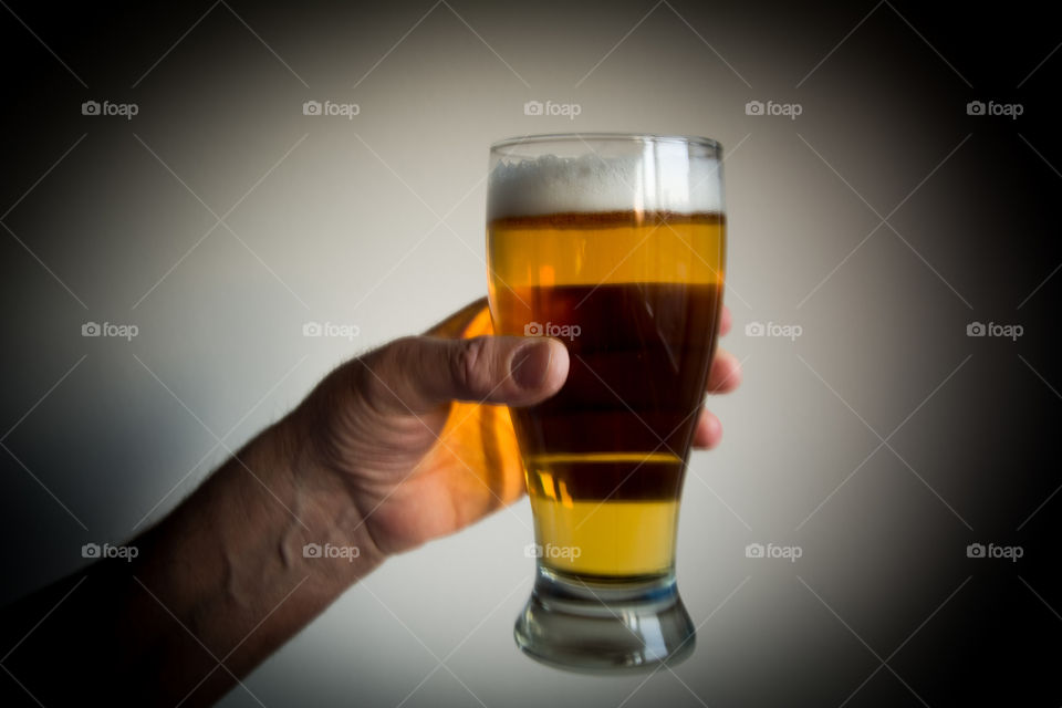 Light yellow beer in male hand