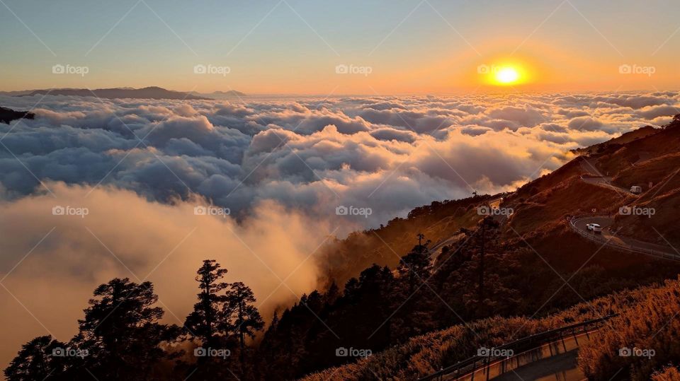 Beautiful sunset natural landscape in the mountains and and sea of clouds in the distance