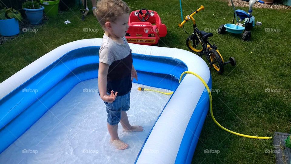 Boy in paddling pool
