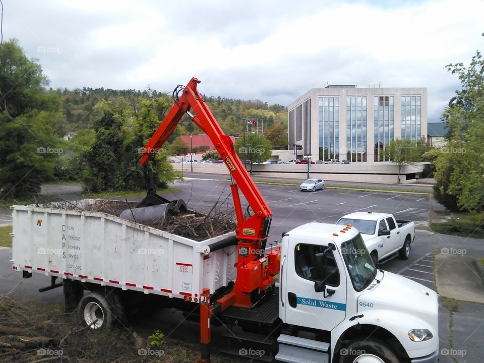 Cleaning up the city downtown   Removing brush