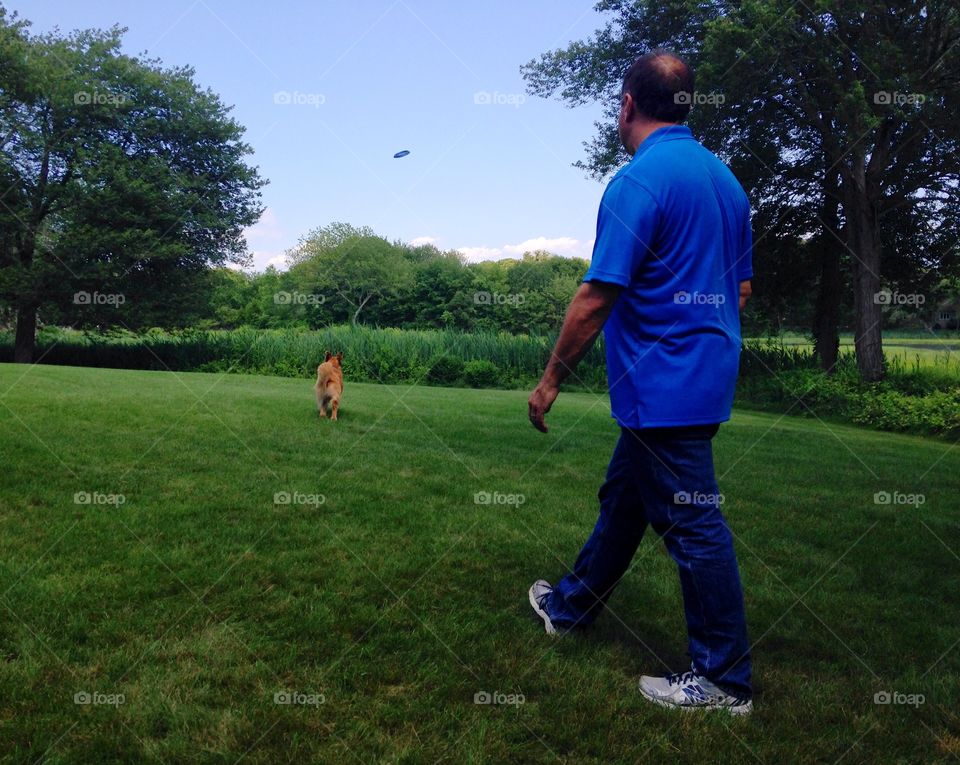 A dog and his human playing some frisbee