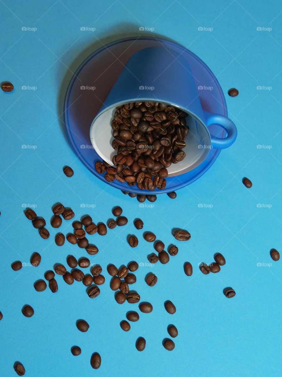 Blue coffee cup and coffee beans