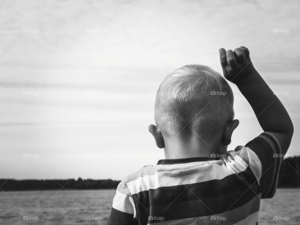 boy throwing rocks in the water