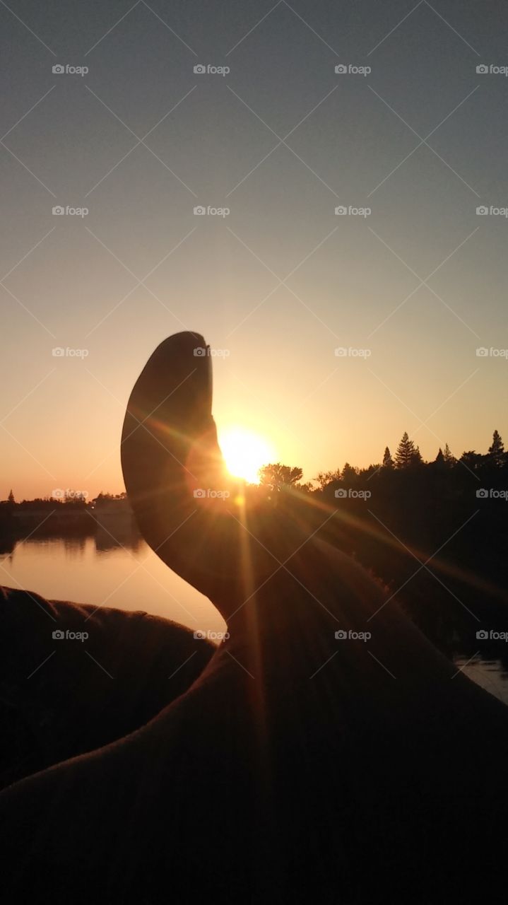 a thumb up signifying a beautiful sunset
