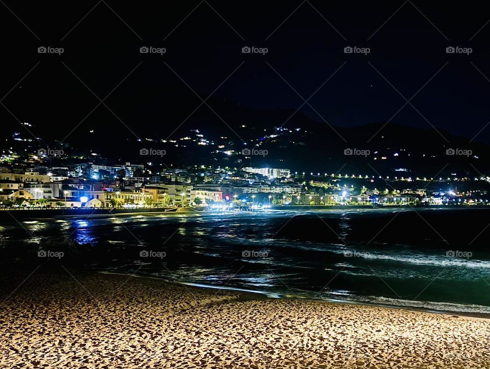 Spiaggetta Del Porto in Cefalù, Italy at night.