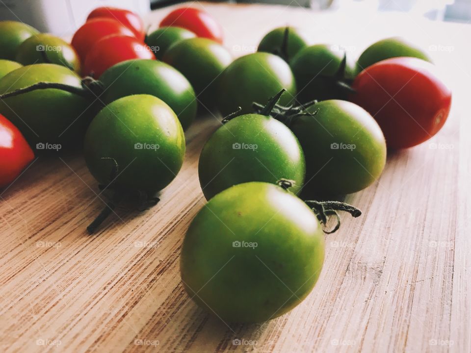 Close-up of green and red cherry tomatoes. 