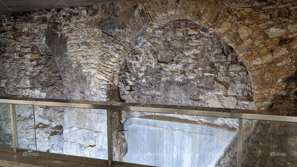 Parts of the old bridge in the vestibule of the metro station. Archaeological excavations.