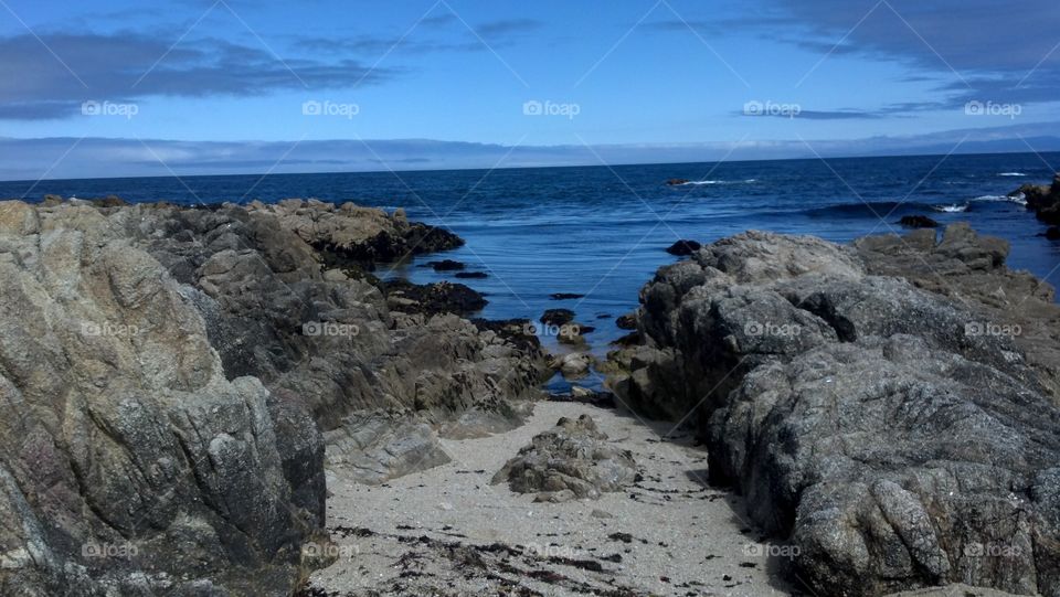 Rocky beach, blue ocean. Blue ocean, blue sky and rocky beach in California by tanu chat