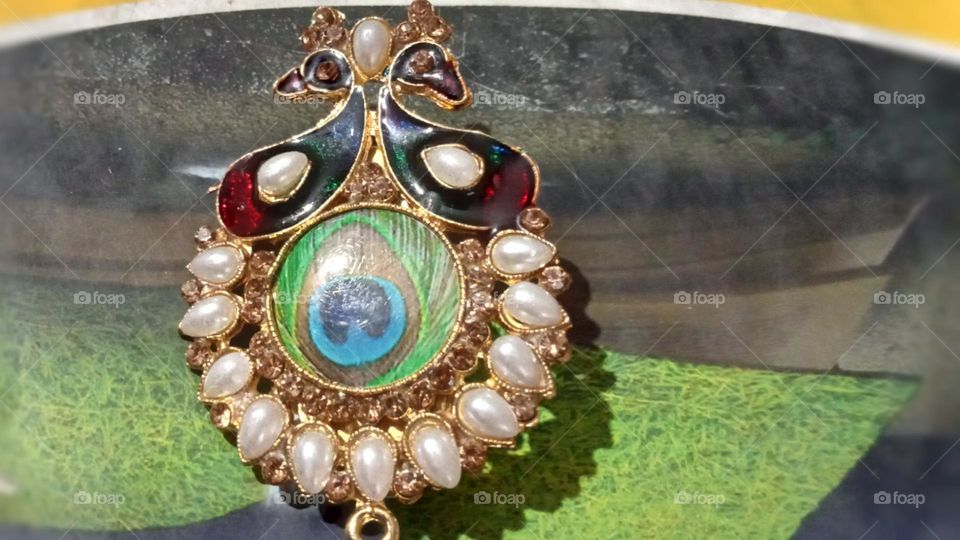 This is beautiful peacock design saree pin photo. This pin is using by women to wear saree for comfortable way. Very attractive and beautiful saree pin likes every Indian  women. They feel comfort and happy using this pin.
