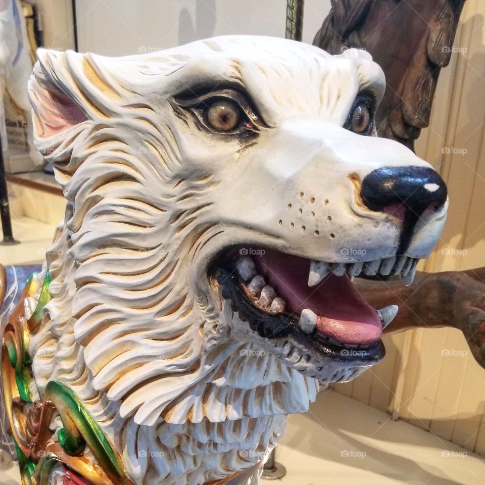 Face of a painted carved wood wolf that was part of a carousel, now in a museum